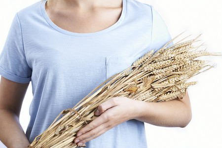 Close Up Of Woman Holding Bundle Of Wheatの写真素材