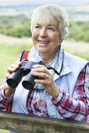 Senior Woman On Walk With Binocularsの写真素材