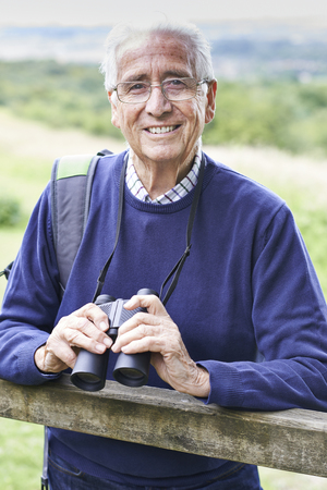 Portrait Of Senior Man On Walk With Binocularsの写真素材