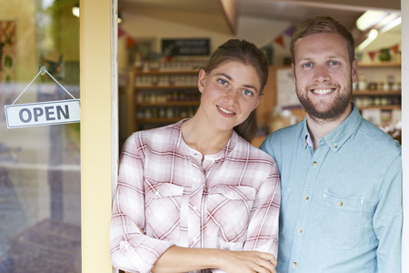 Portrait Of Couple Running Delicatessen Outside Store