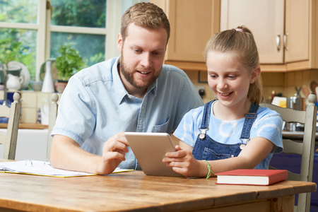 Male Home Tutor Helping Girl With Studiesの写真素材