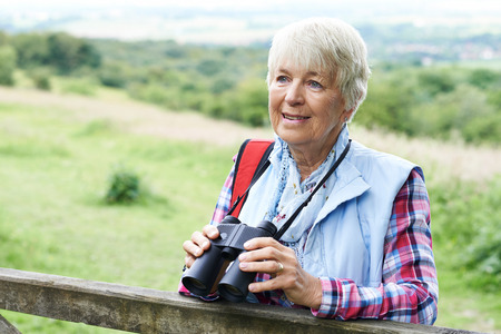 Senior Woman On Walk With Binocularsの写真素材