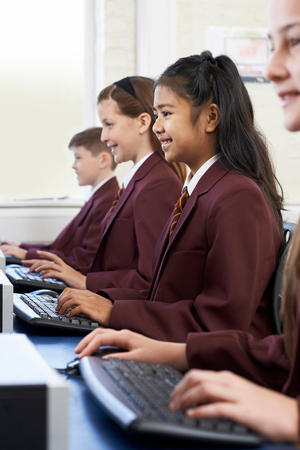 Pupils Wearing School Uniform In Computer Class の写真素材