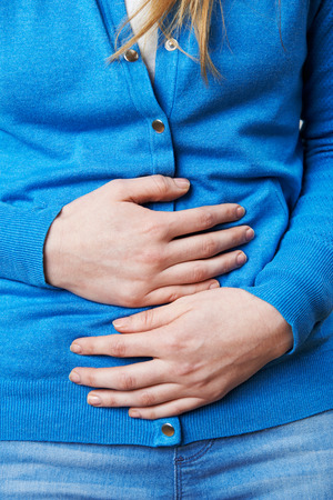 Close Up Of Woman Suffering With Stomach Painの写真素材