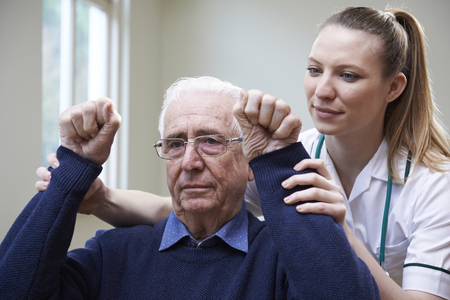 Nurse Assessing Stroke Victim By Raising Armsの写真素材
