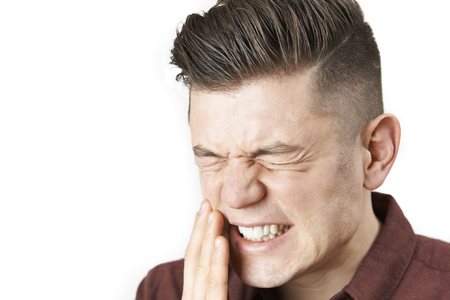 Studio Portrait Of Man Suffering With Toothacheの写真素材