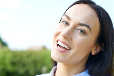 Outdoor Portrait Of Woman With Perfect Teeth And Beautiful Smileの写真素材
