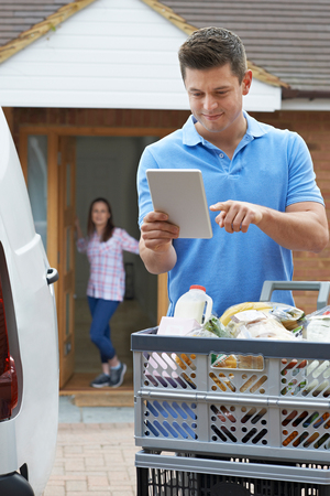Driver Delivering Online Grocery Order To Houseの写真素材
