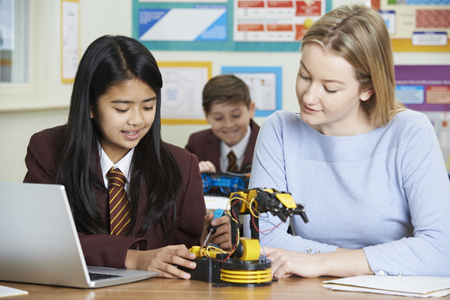 Teacher With Female Pupil In Science Lesson Studying Roboticsの写真素材