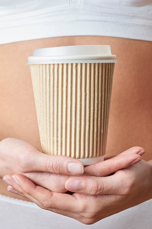 Close Up Of Woman Wearing Underwear Holding Cup Of Takeaway Coffeeの写真素材