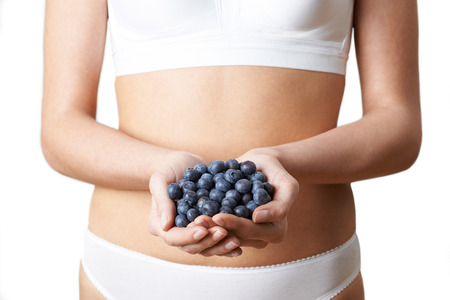 Close Up Of Woman In Underwear Holding Fresh Blueberriesの写真素材