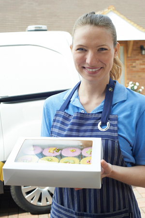 Female Baker Making Home Delivery Of Cupcakesの写真素材
