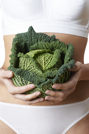 Close Up Of Woman In Underwear Holding Cabbageの写真素材