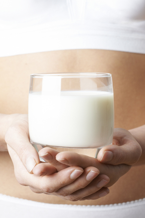 Close Up Of Woman Wearing Underwear Drinking Glass Of Fresh Milk の写真素材