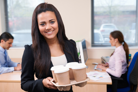 Female Intern Fetching Coffee In Officeの写真素材