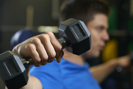 Man In Gym Exercising With Weightsの写真素材