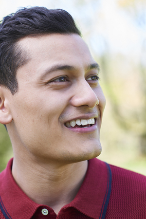 Outdoor Head And Shoulders Portrait Of Smiling Young Manの写真素材