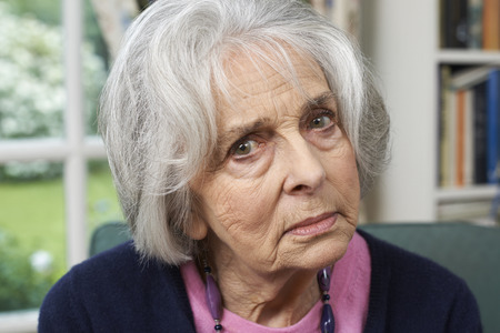 Head And Shoulders Portrait Of Unhappy Senior Woman At Homeの写真素材