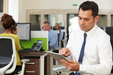 Businessman Using Digital Tablet In Modern Officeの写真素材