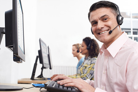 Portrait Of Male Customer Services Agent In Call Centreの写真素材