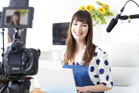 Portrait Of Female Vlogger Recording Broadcast At Homeの写真素材