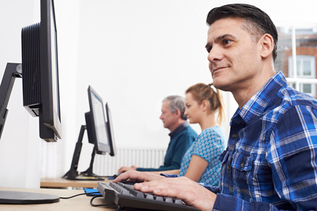 Mature Man Attending Computer Class In Front Of Screenの写真素材