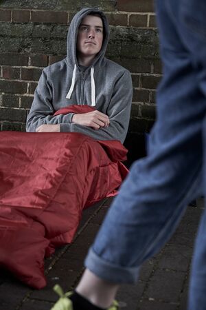 Vulnerable Teenage Boy Sleeping On The Streetの写真素材