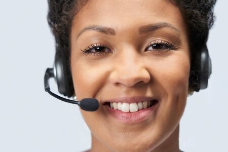 Portrait Of Businesswoman Wearing Telephone Headset In Customer Services Departmentの写真素材