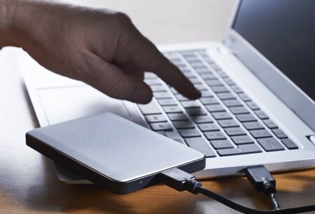Data Being Illegally Downloaded From Computer Onto External Hard Driveの写真素材