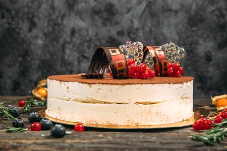 Side view on gourmet sweet appetizing cake with decorative elements and berries, horizontalの写真素材