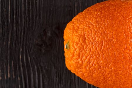 Top view closeup on fresh orange fruit on the dark wooden background, horizontal formatの写真素材