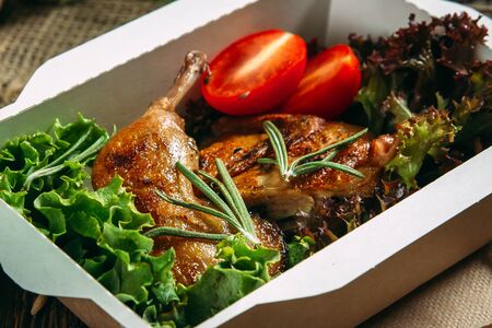 Closeup on appetizing roasted chicken legs with vegetables, horizontal formatの写真素材