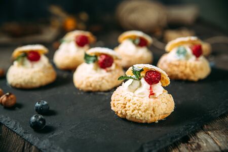 Sweet gourmet dessert cookies with cream and berries, horizontal