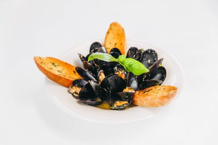 Appetizing mussels dish with sauce and bread toasts, horizontalの写真素材