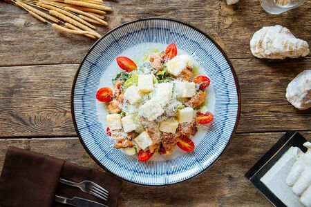 Top view on gourmet appetizing caesar salad with fried chicken, horizontalの写真素材