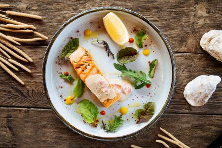 Top view on grilled salmon fillet on the wooden table, horizontalの写真素材