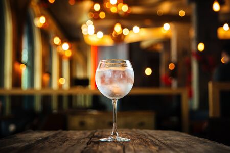 Side view on fresh cool cocktail gin tonic on the wooden table, horizontal