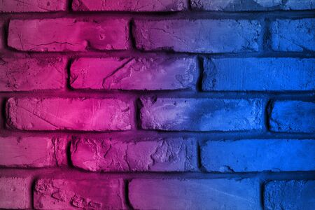 Lighting Neon Effect red and blue on brick wall for background. Showing products or placing products. Neon light on brick walls. Purple and cyanの写真素材