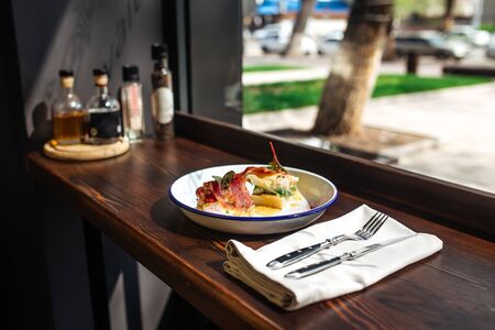 Morning bruschetta toasts with bacon and vegetables on the table, horizontal