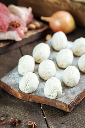 uncooked Manti. Central Asian traditional meat dish with meat and onions. Unprepared, raw. Vertical viewの写真素材