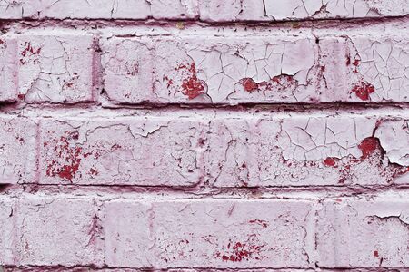 Old dusty vintage pink brick wall with peeling paint texture background, horizontalの写真素材