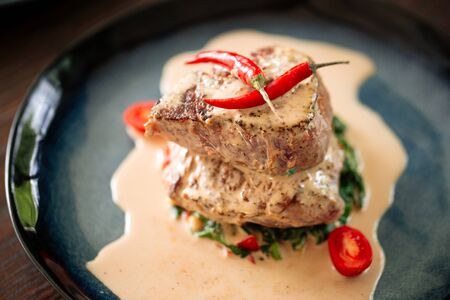 Closeup on appetizing fillet mignon steaks with sauce on the plate, horizontalの写真素材