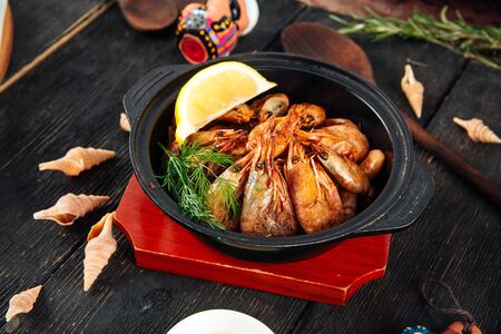 Closeup on cooked appetizer shrimps with lemon beer snack in a bowl, horizontal