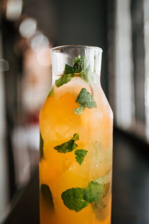 Closeup on fresh fruit lemonade in a glass jar with mint leaves, verticalの写真素材