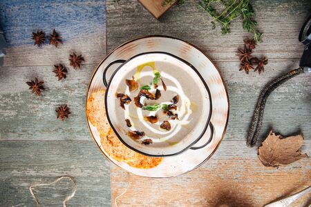 Top view on gourmet muchroom cream soup on the wooden table, horizontalの写真素材