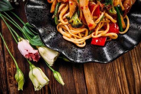 Top view closeup on asian cuisine chicken and vegetables udon noodles wok, horizontalの写真素材