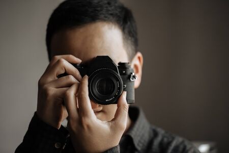 man holds film vintage cameraの写真素材