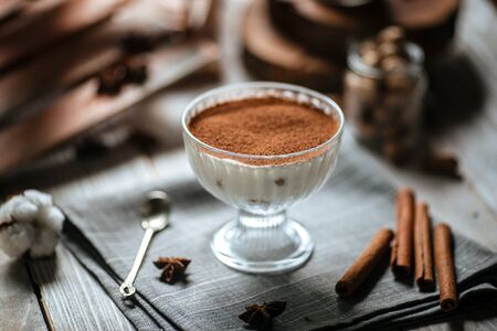 Sweet dessert tiramisu in a glass on the grey napkin, horizontalの写真素材
