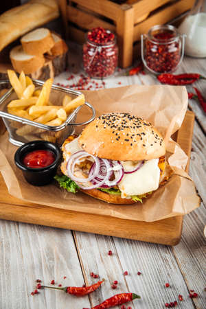 Juicy turkey pineapple and tender cheese  burger set with fries and sauce, verticalの写真素材