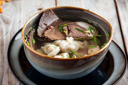 Closeup on kazakh style soup sorpa with kazy horse meat sausage broth, horizontal
